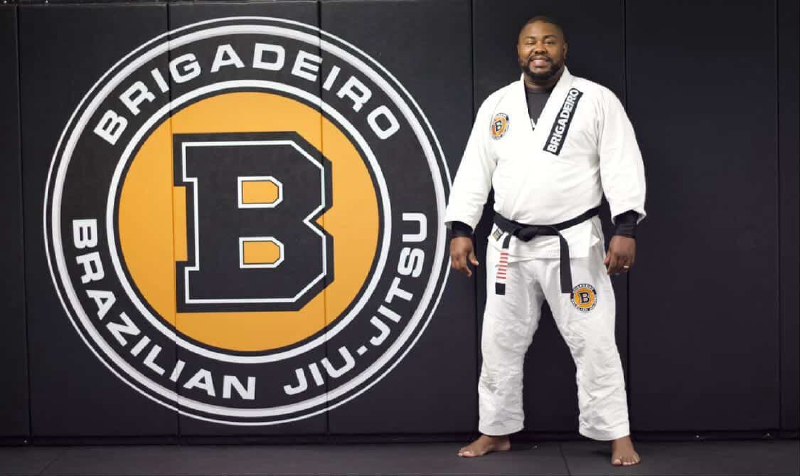Grandmaster Eduardo Brigadeiro in front of the Brigadeiro Brazilian Jiu-Jitsu mark